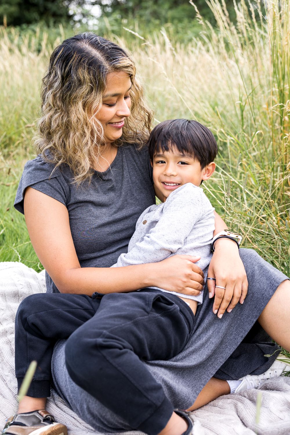 mum and son cuddling on the grass