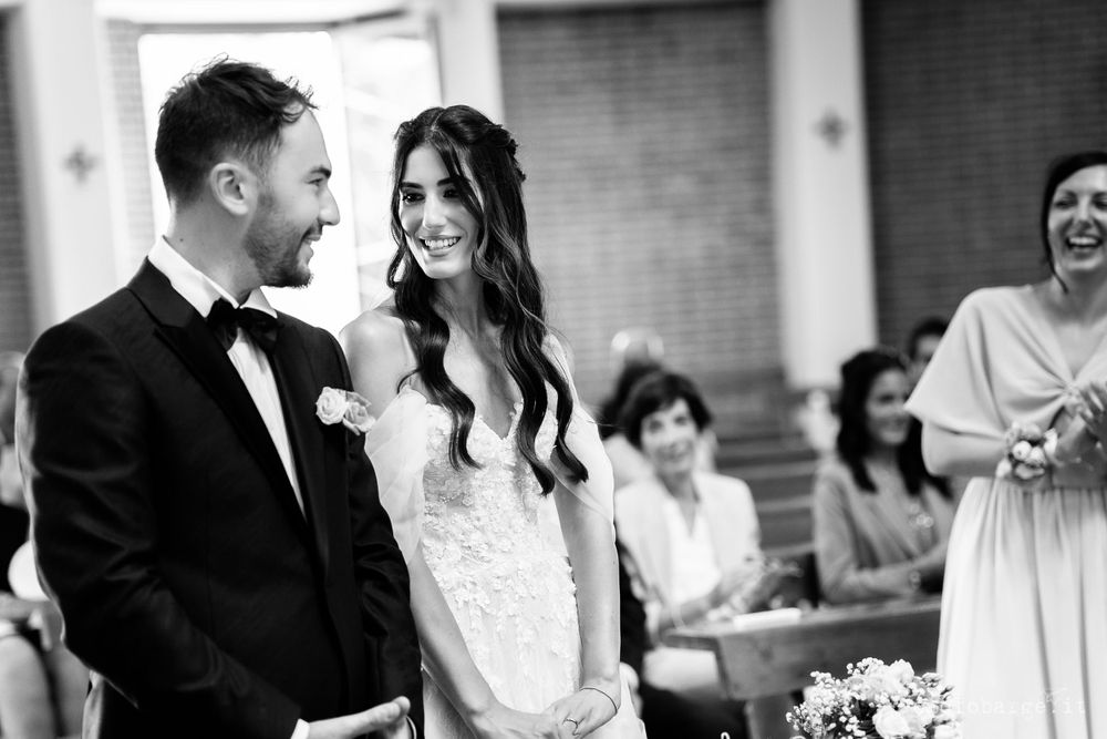A joyful moment captured in black and white during a wedding ceremony.