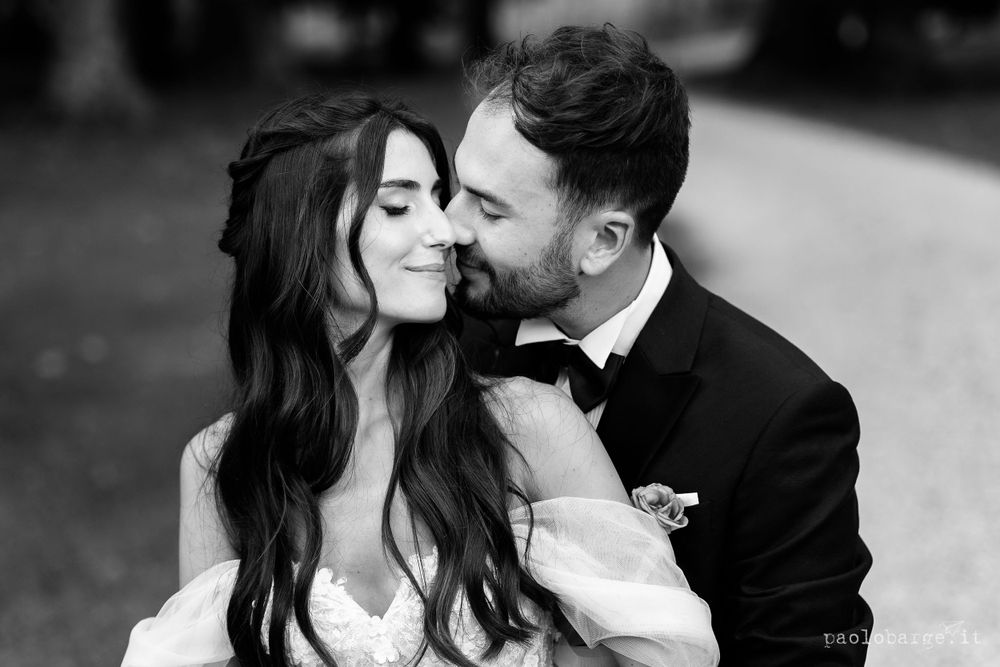 Intimate black and white portrait of a romantic couple in formal attire.