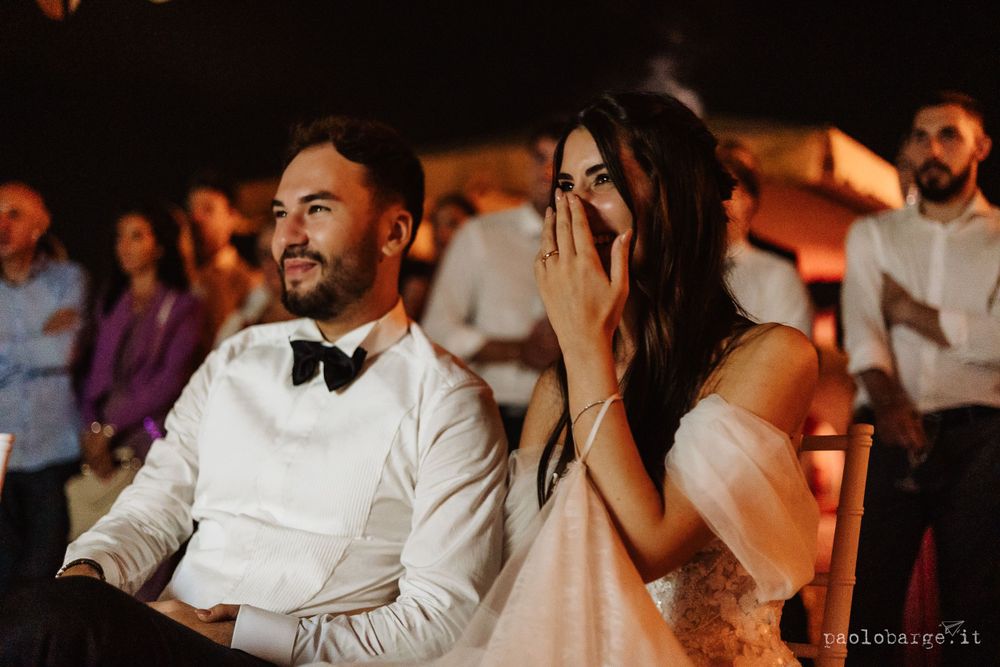 Couple sharing an emotional moment during wedding reception entertainment.