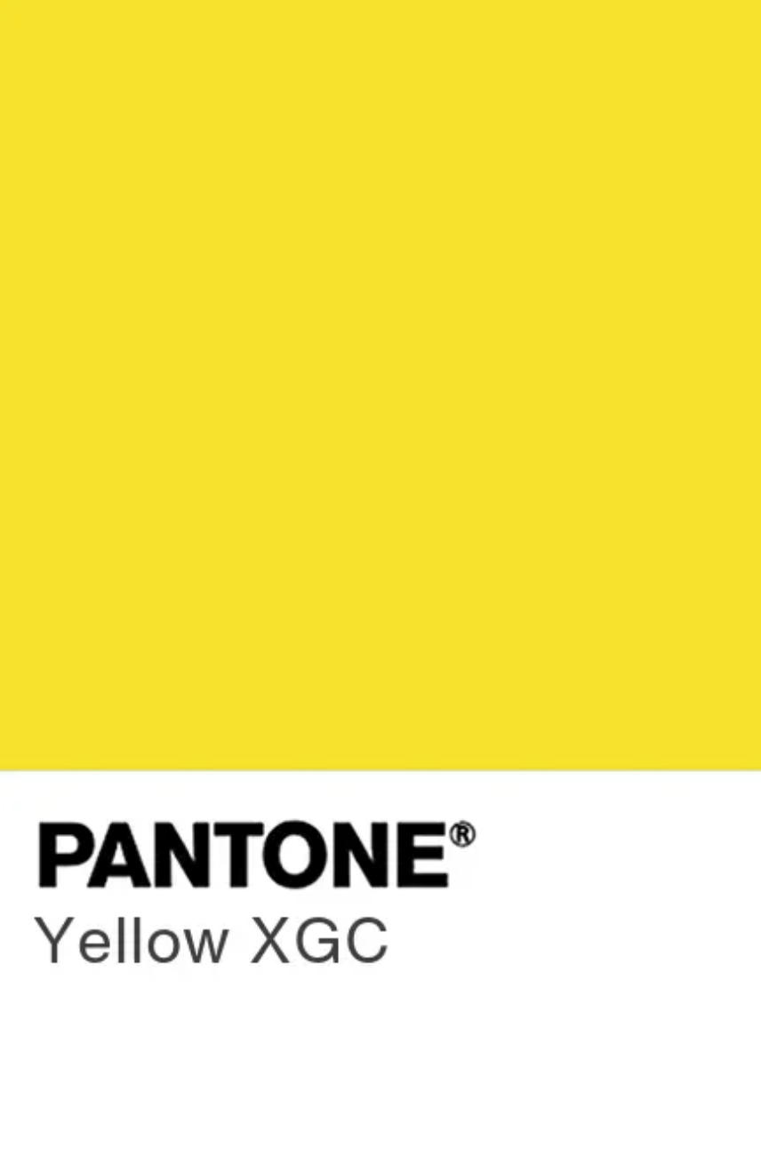 Artistic beauty portrait with vibrant yellow wig against warm golden background.