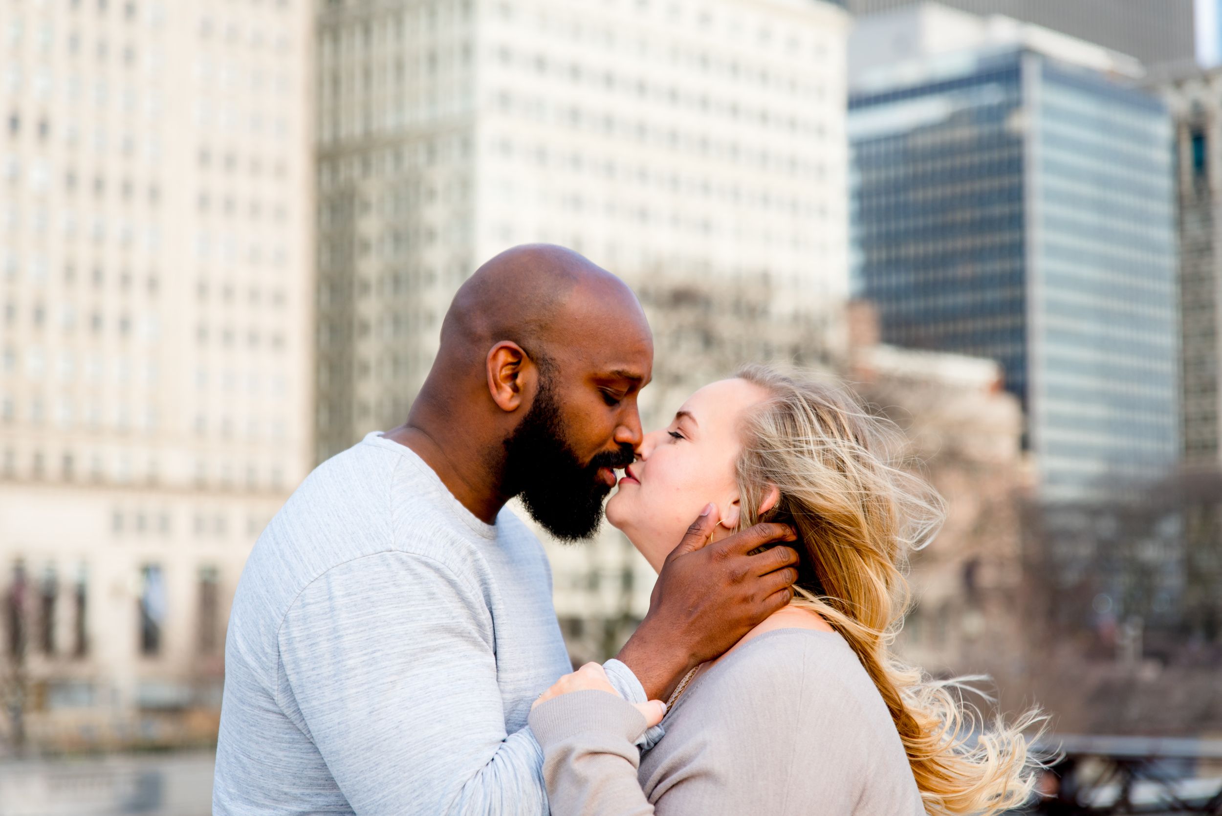 man and woman almost kissing in front of Michigan Ave for downtown Chicago sunrise engagement photos