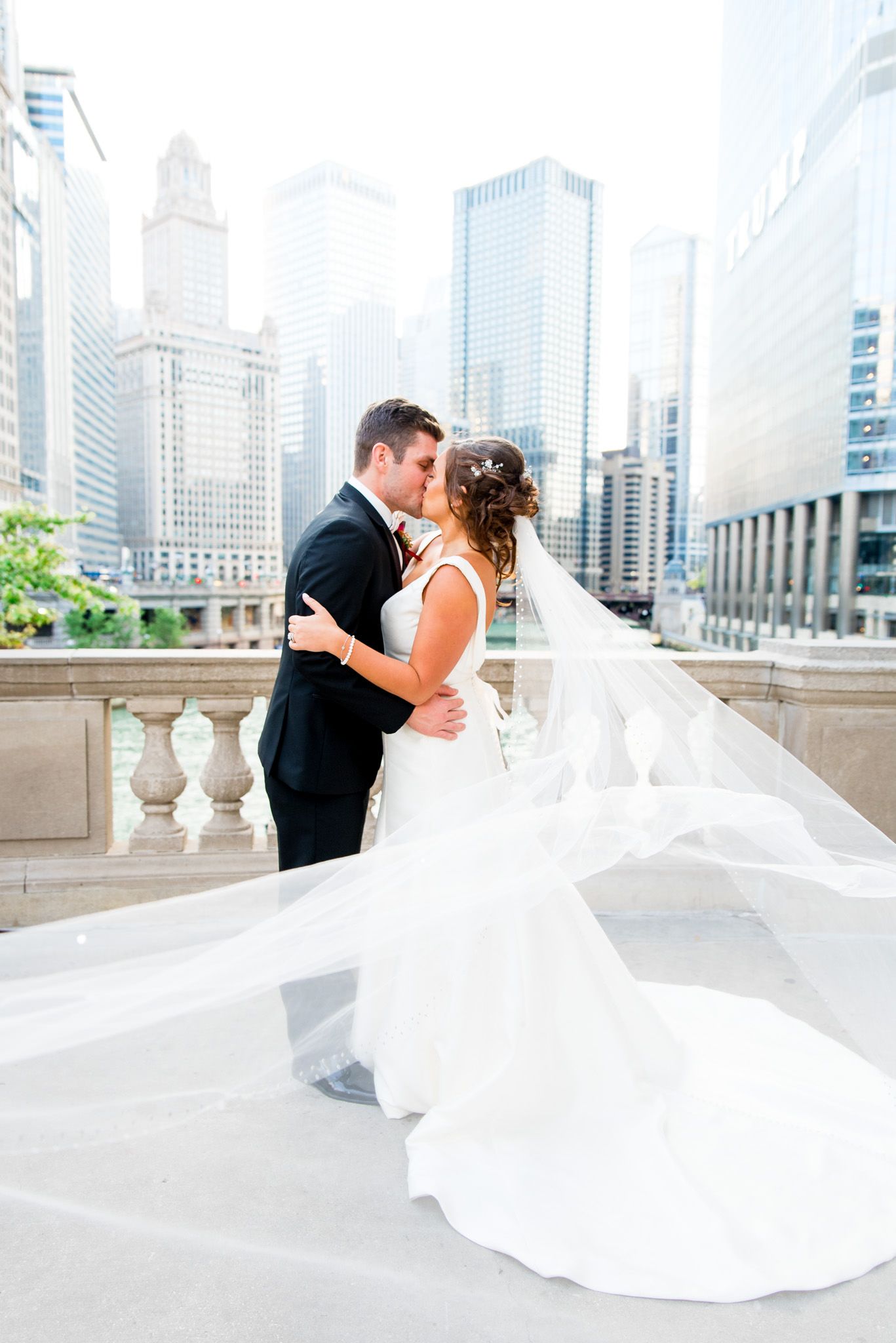 black tux and white wedding dress photography near riverwalk in downtown chicago