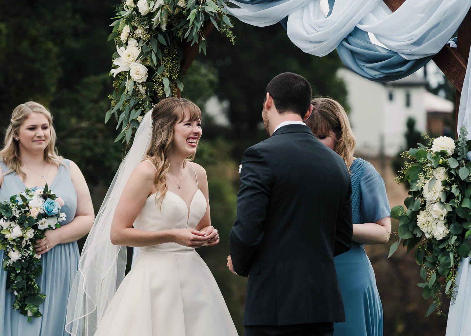 bride laughing at the alter during wedding ceremony