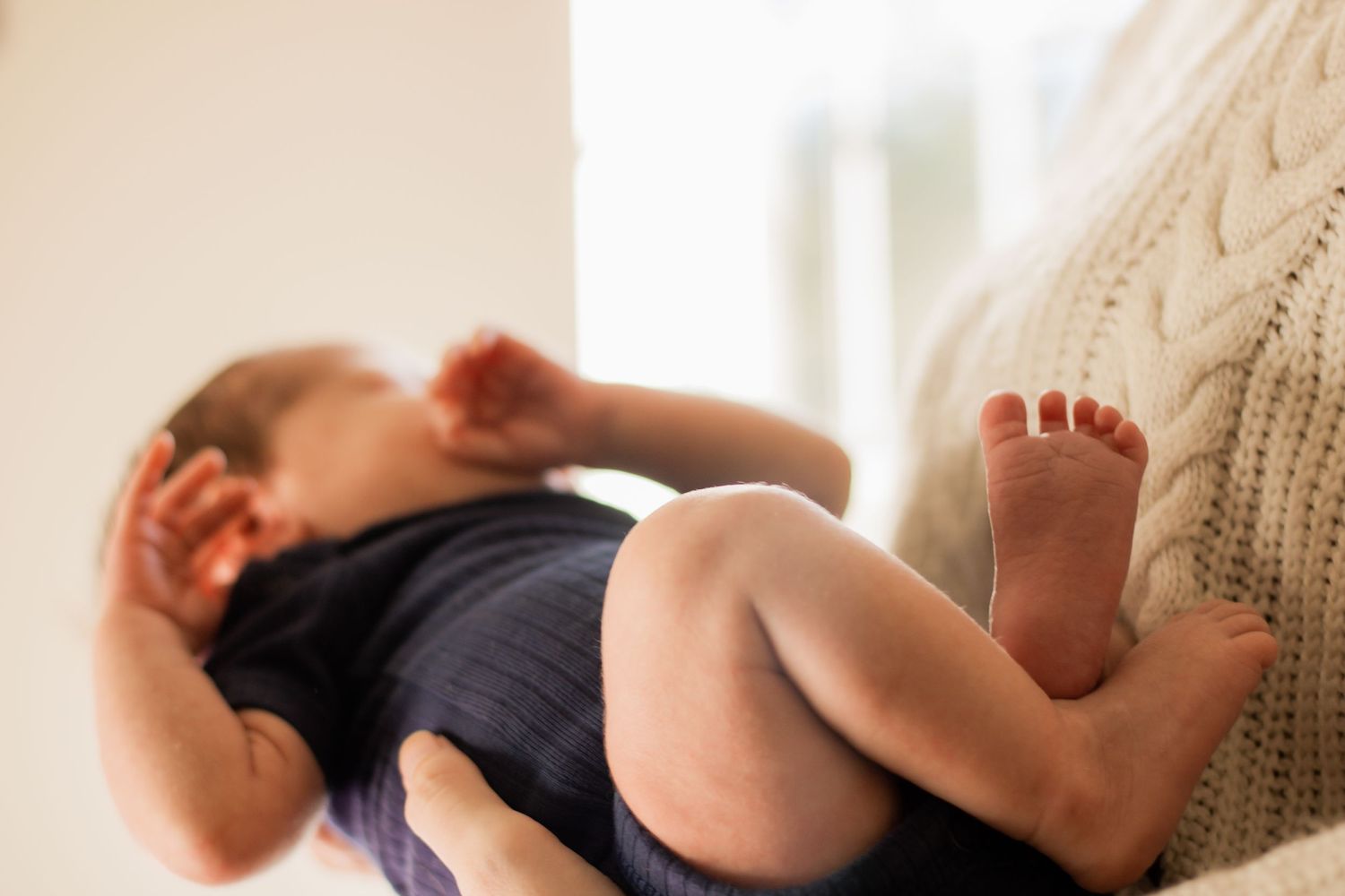 Newborn baby held by mom