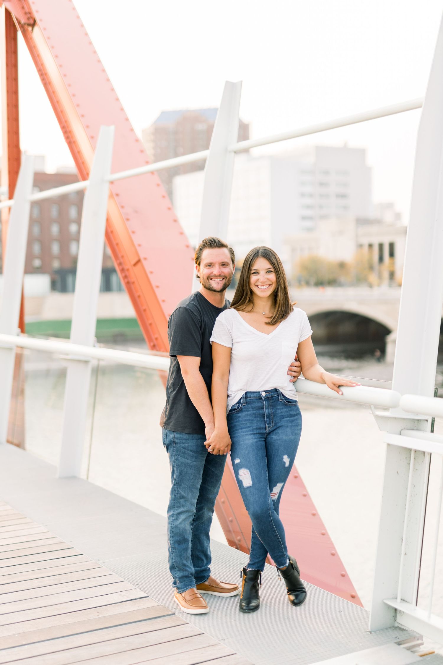 Des Moines Engagement photos in downtown Des Moines, Iowa with light and airy photographer Nicole Laing