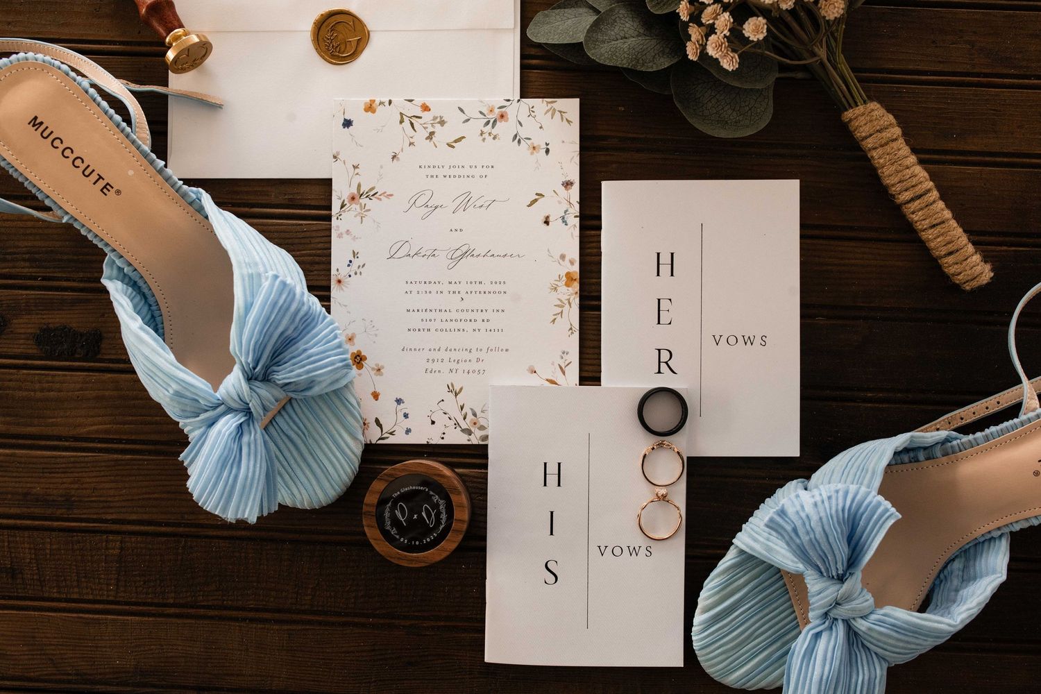 Wedding accessories including beige heels, jewelry, black rings and handwritten notes arranged on a rustic white surface.