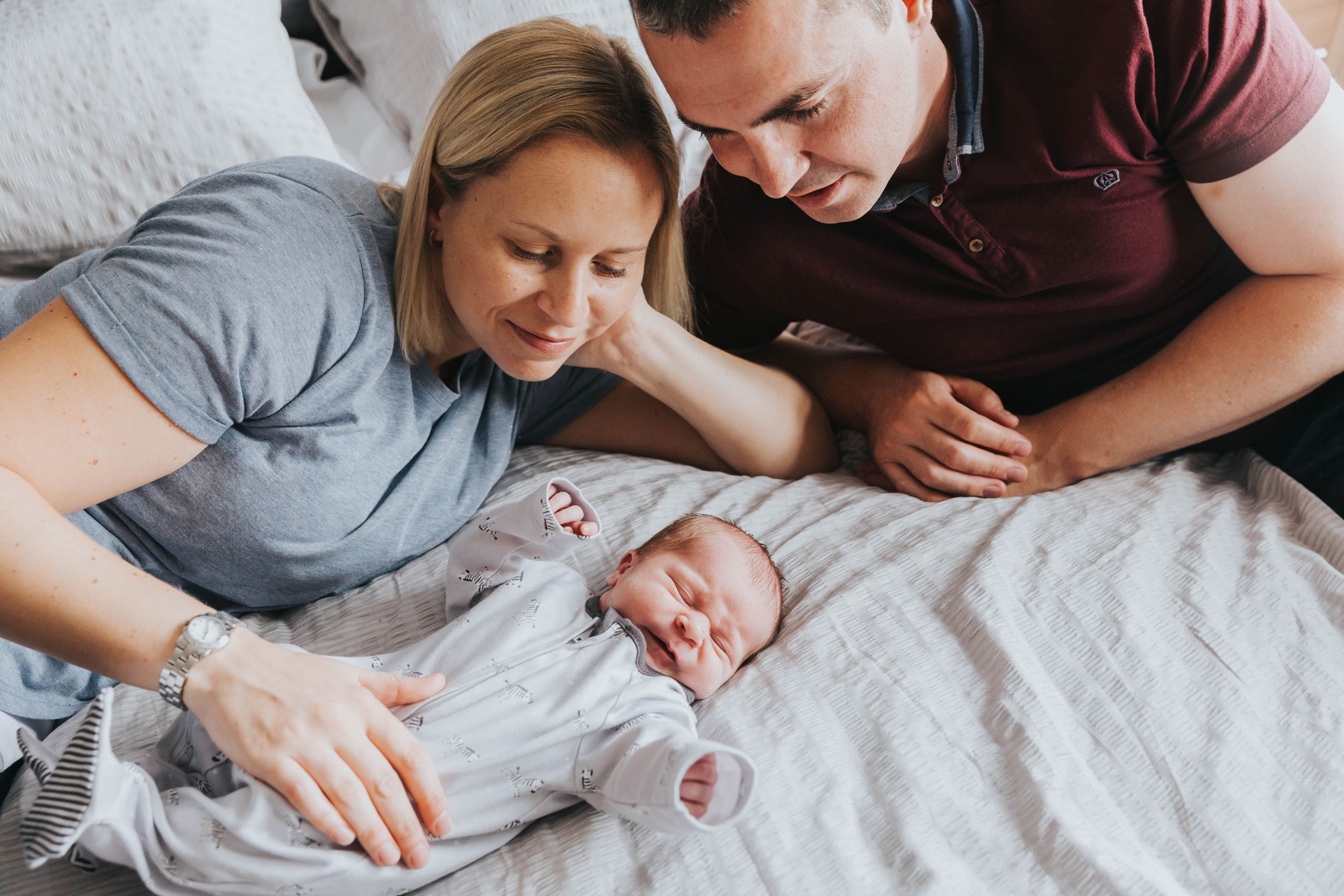 parents looking at one week old baby boy