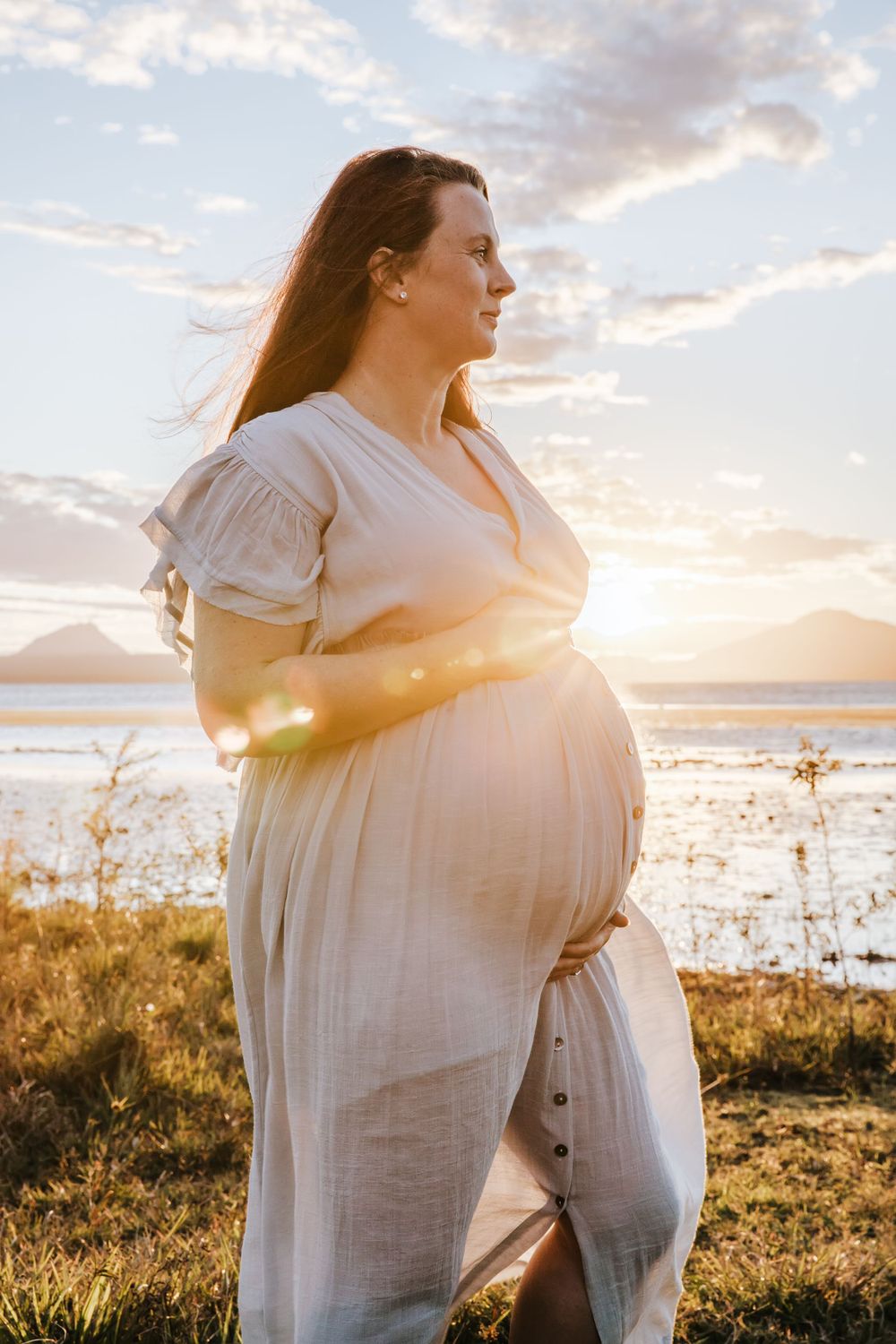beautiful pregnant lady holing her belly for a photoshoot