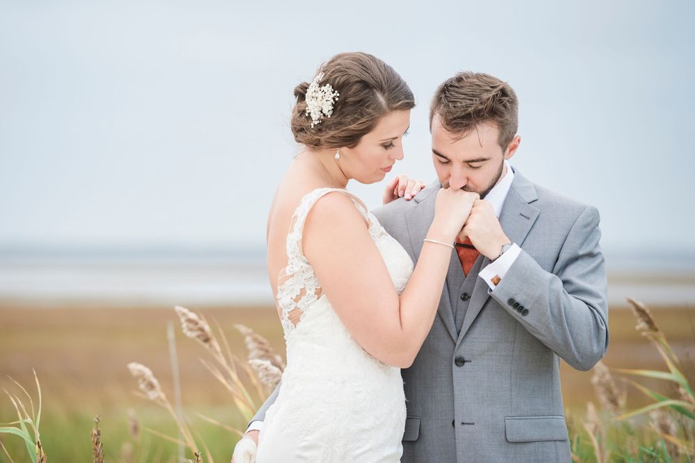wedding photo of groom kissing the bride's hand at Bonnet Island Estate