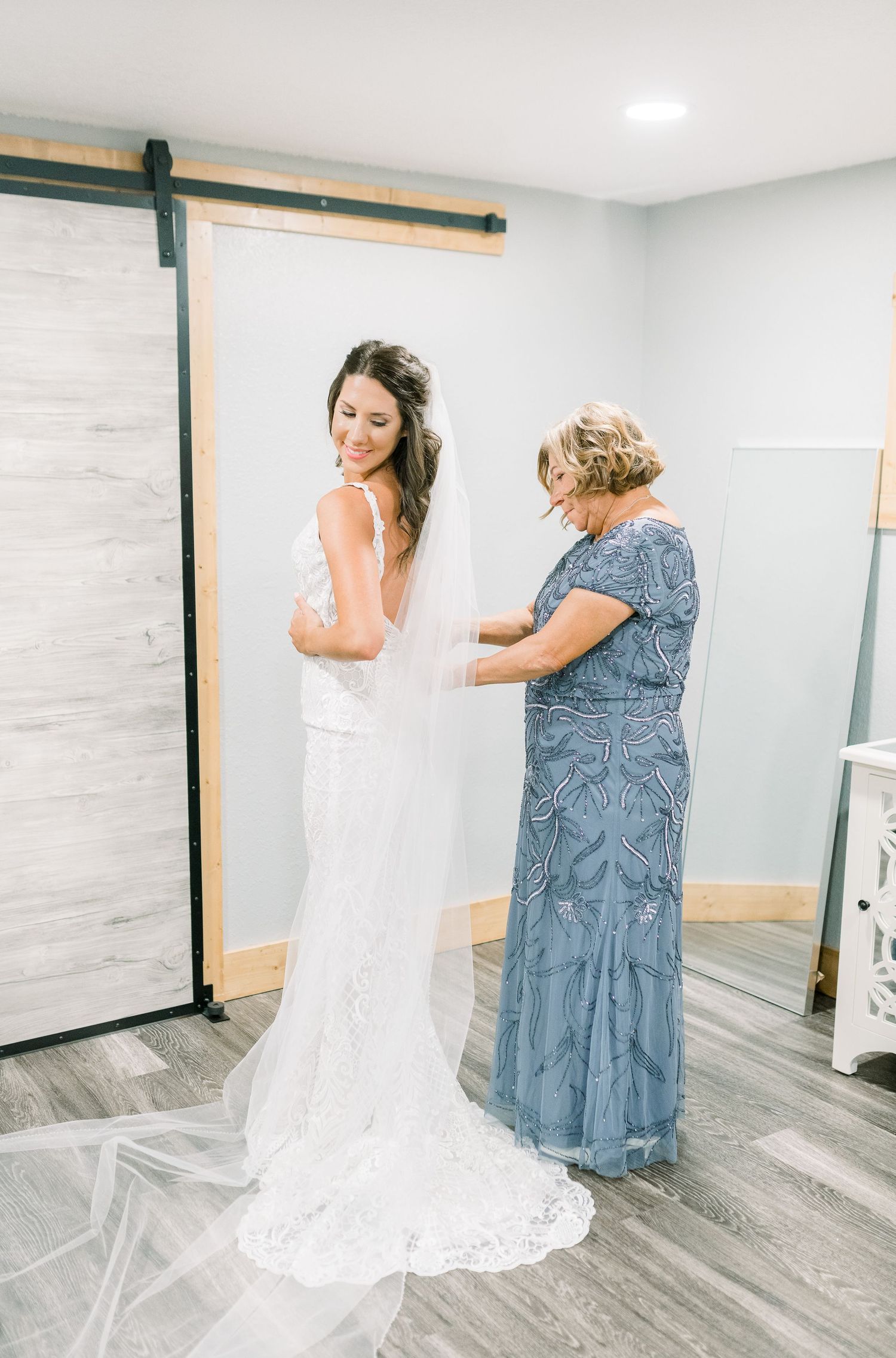 Getting ready dress zipping photos in at Prairie Moon Winery wedding in Ames, Iowa