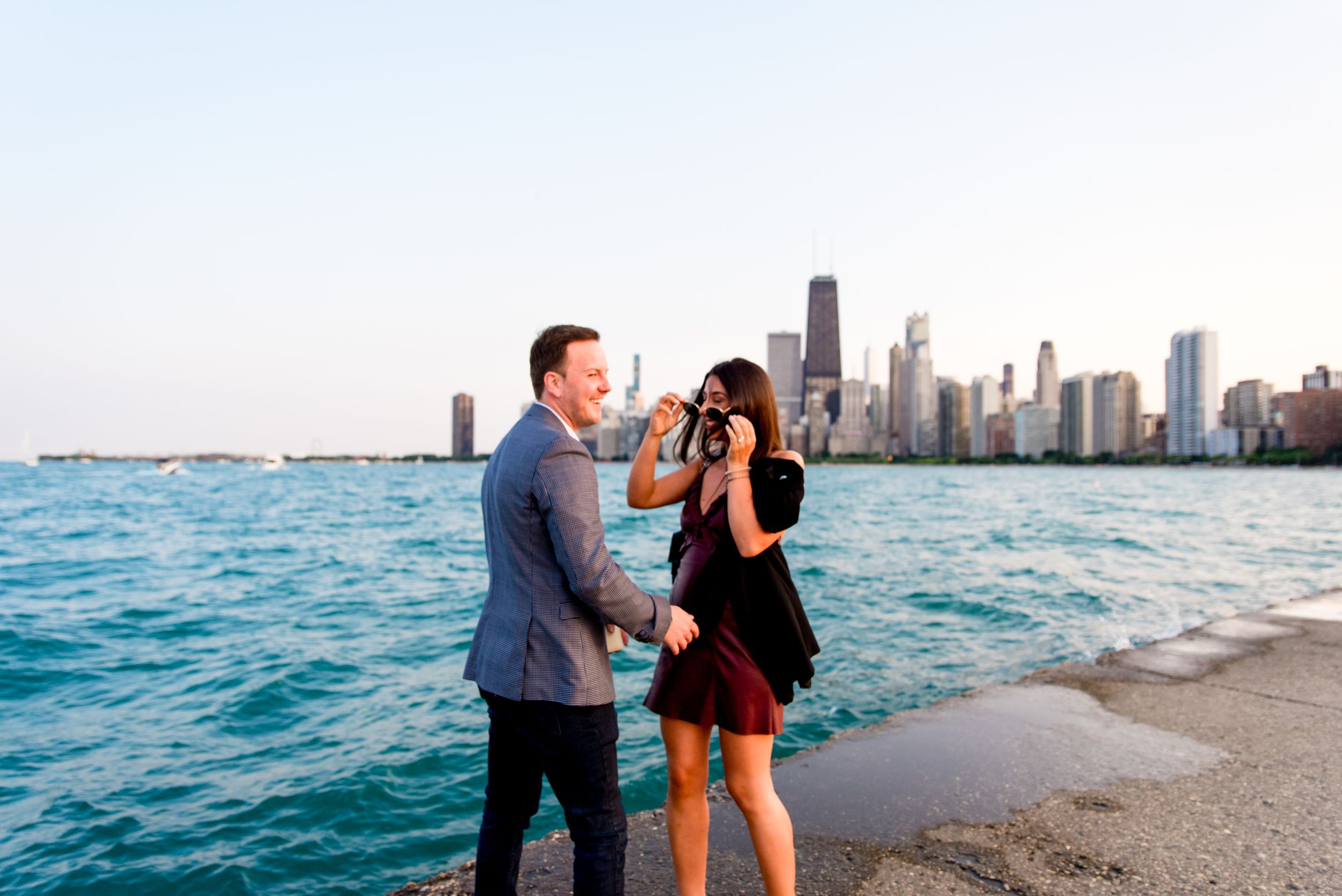 man and woman hugging after Chicago proposal at North Avenue Beach pier