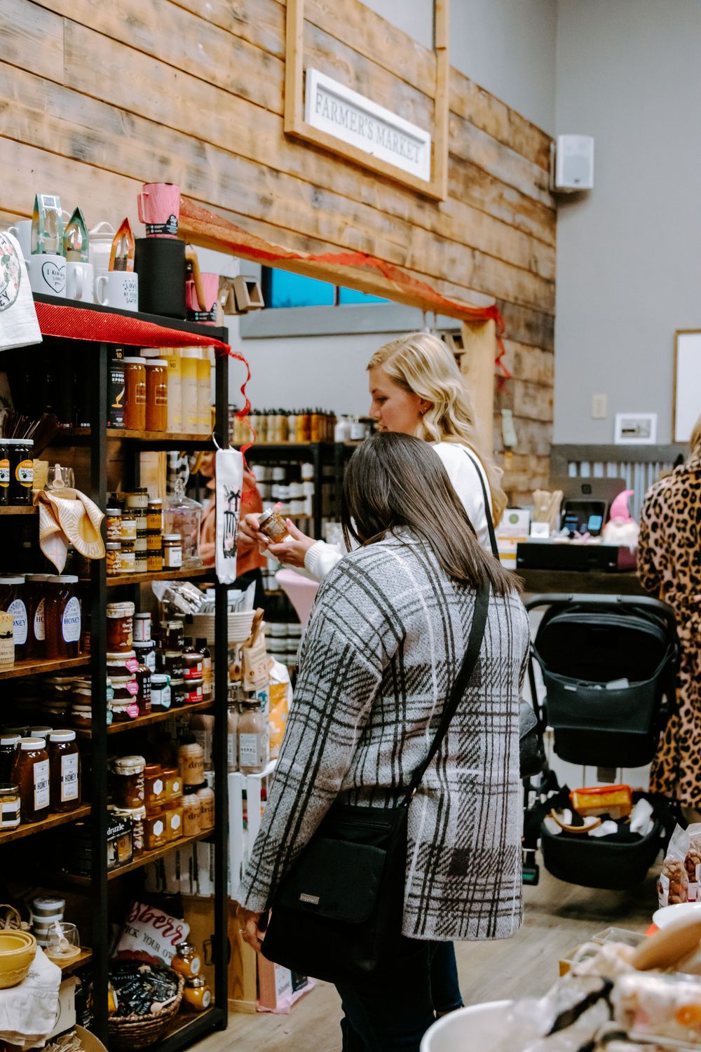 Shopping scene in a rustic store with wooden shelving displaying various products and merchandise.