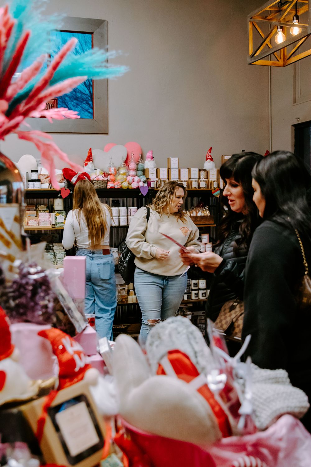 Customers browsing in a retail store with holiday decorations and product displays.