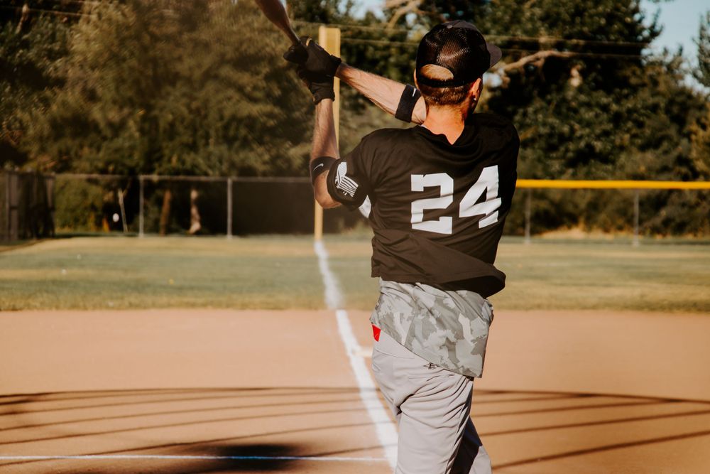 Baseball player wearing number 24 jersey takes batting stance during game.