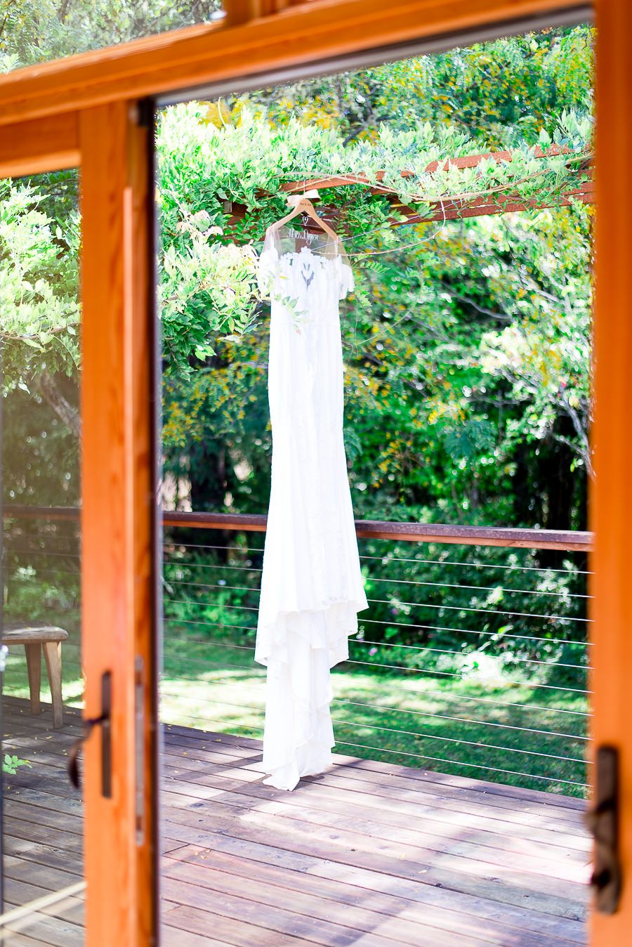 wedding dress hanging from pergola in Northern California patio