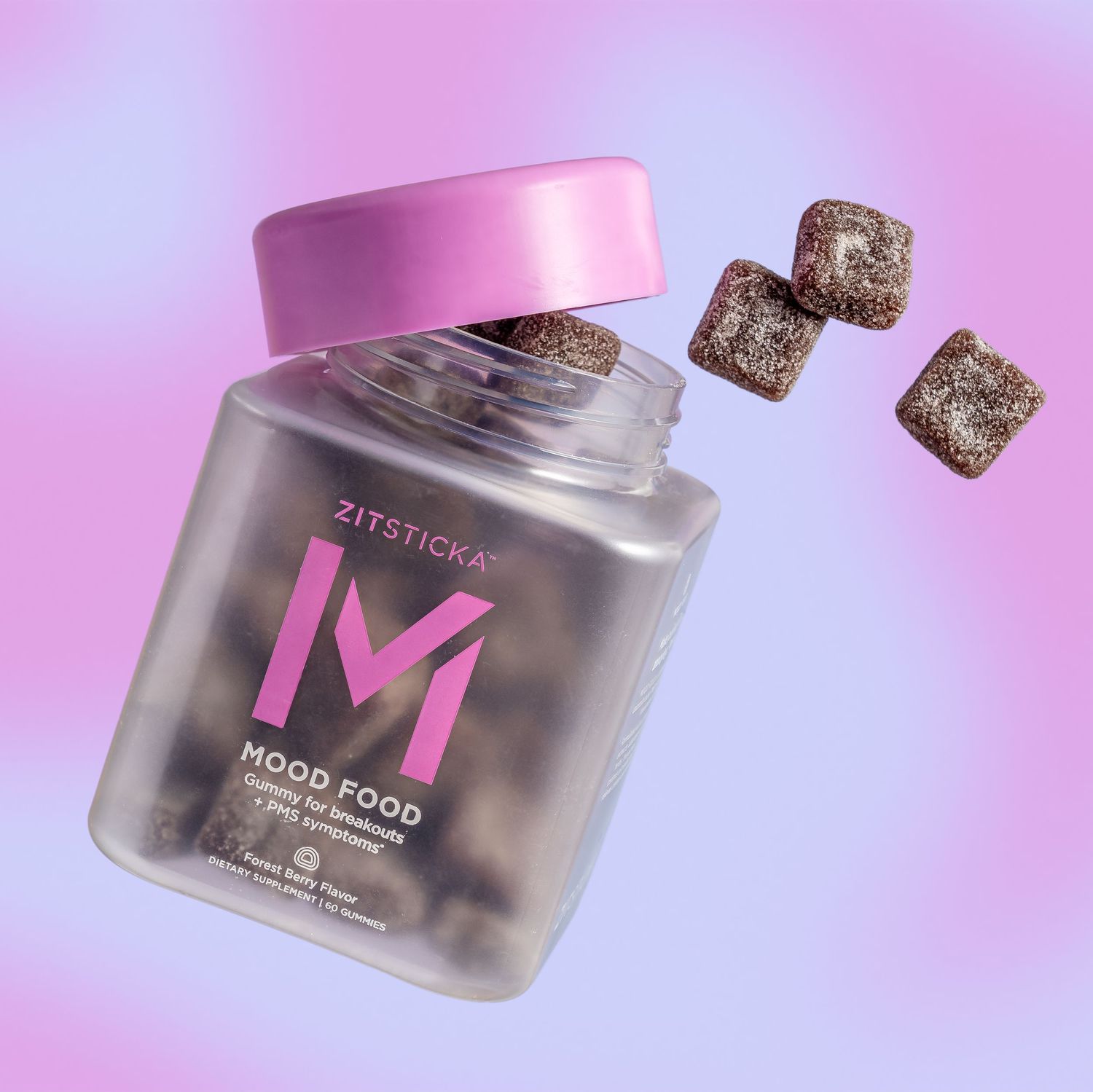 Pink lidded glass jar of mood-enhancing gummies with metallic cubes on purple gradient background.