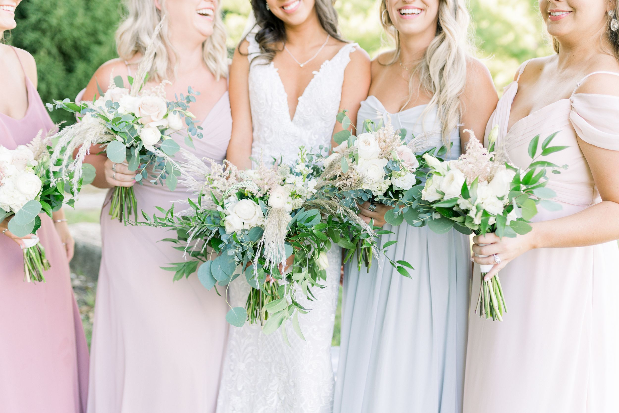 Light and airy summer Des Moines wedding with pastel dresses and florals at Winery in Iowa