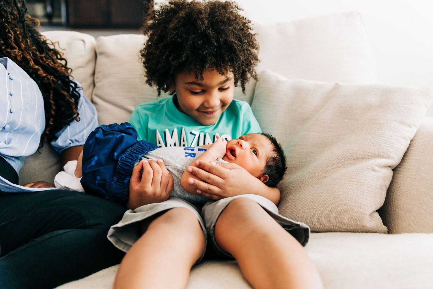 An older brother holding his newborn baby brother