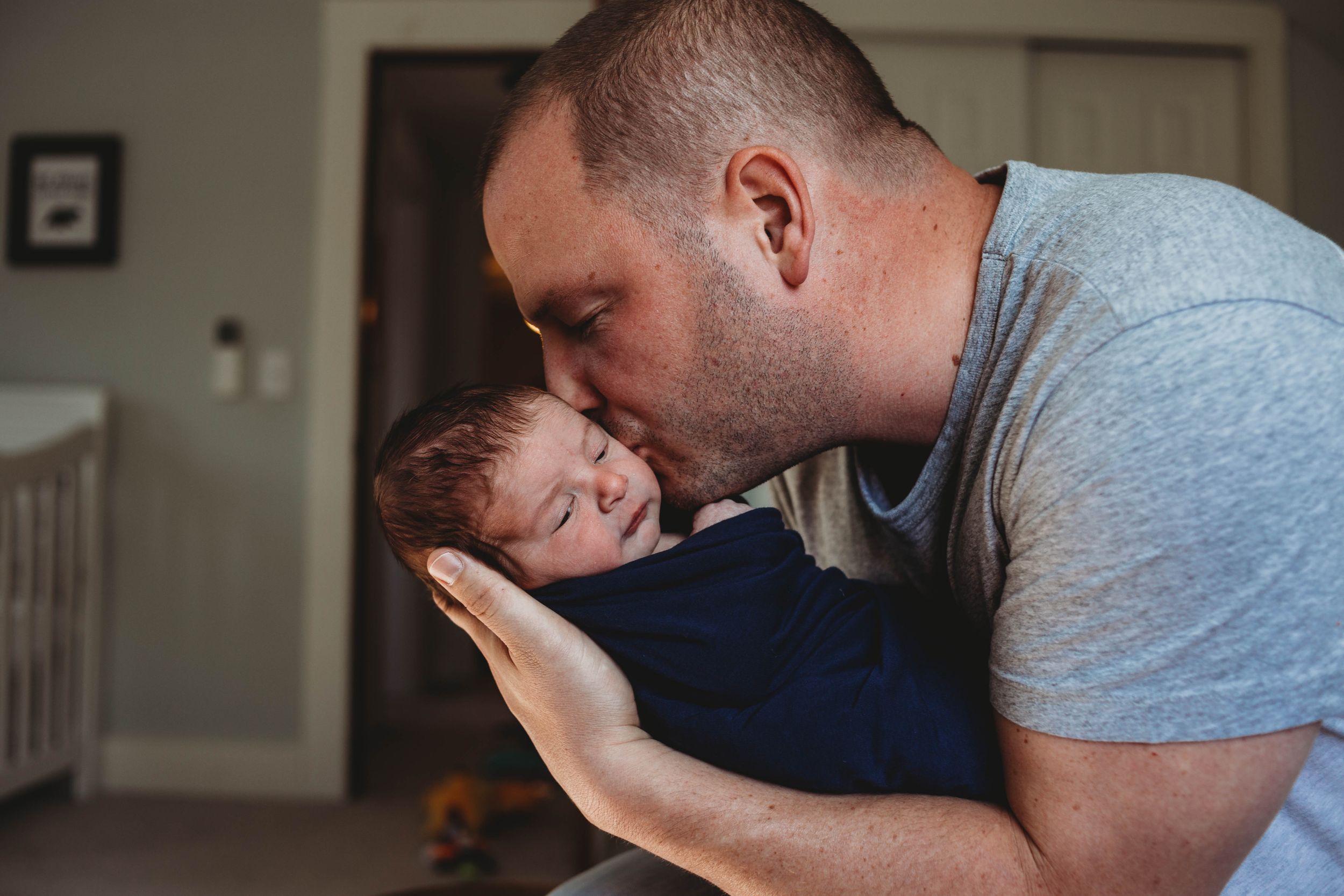 dad kissing his son by lunenburg photographer