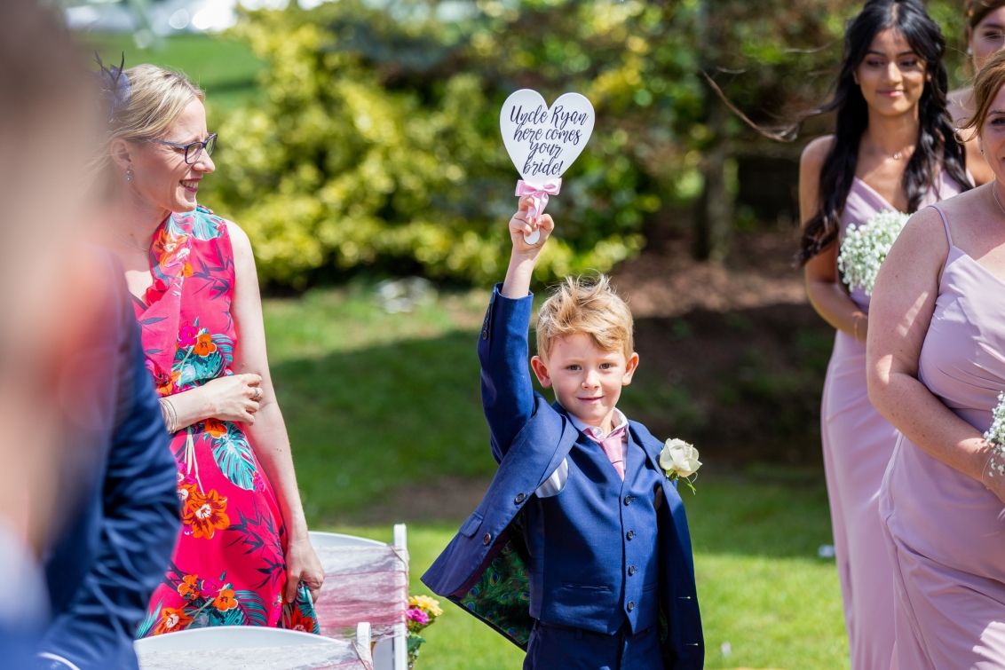 Boy walking through ceremony with plaque in hand.