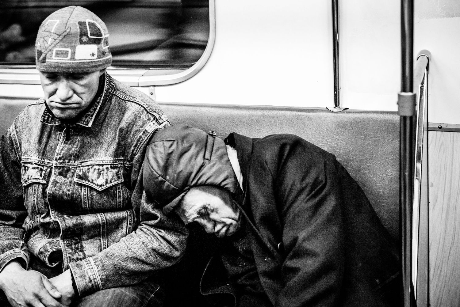 Black and white two men sleeping in underground metro in Moscow Russia