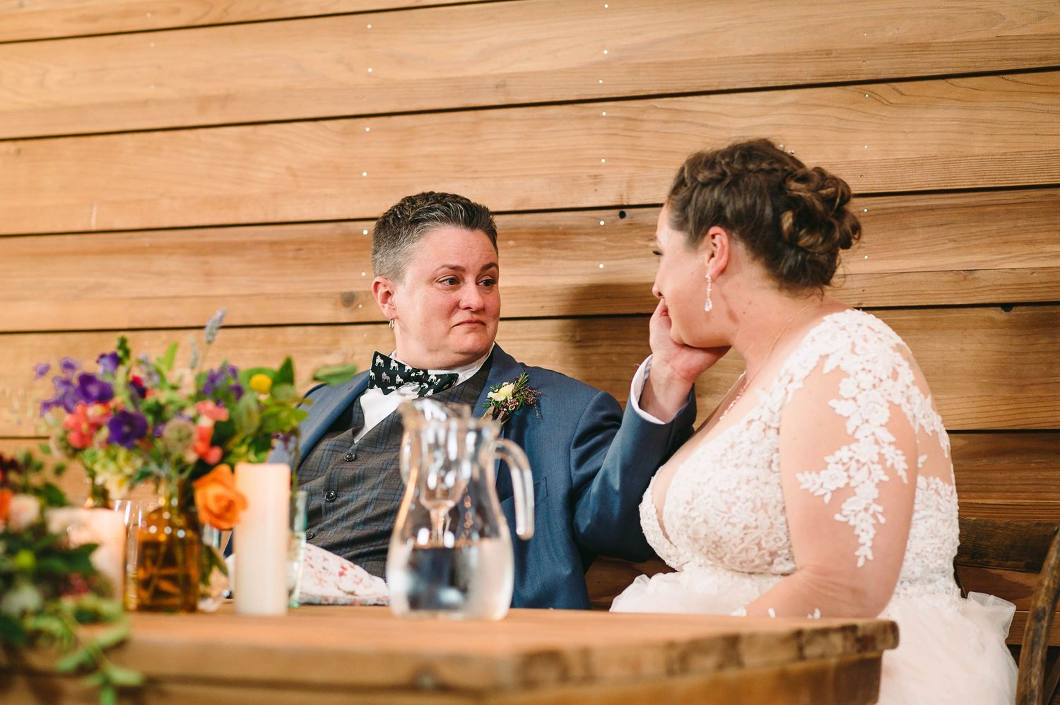 Bride wiping the tear off her brides cheek