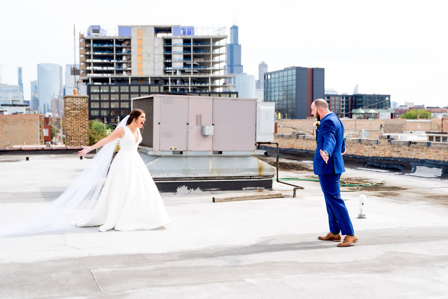 bride and groom have their first look and smile at each other on roof of Room 1520 in downtown Chicago