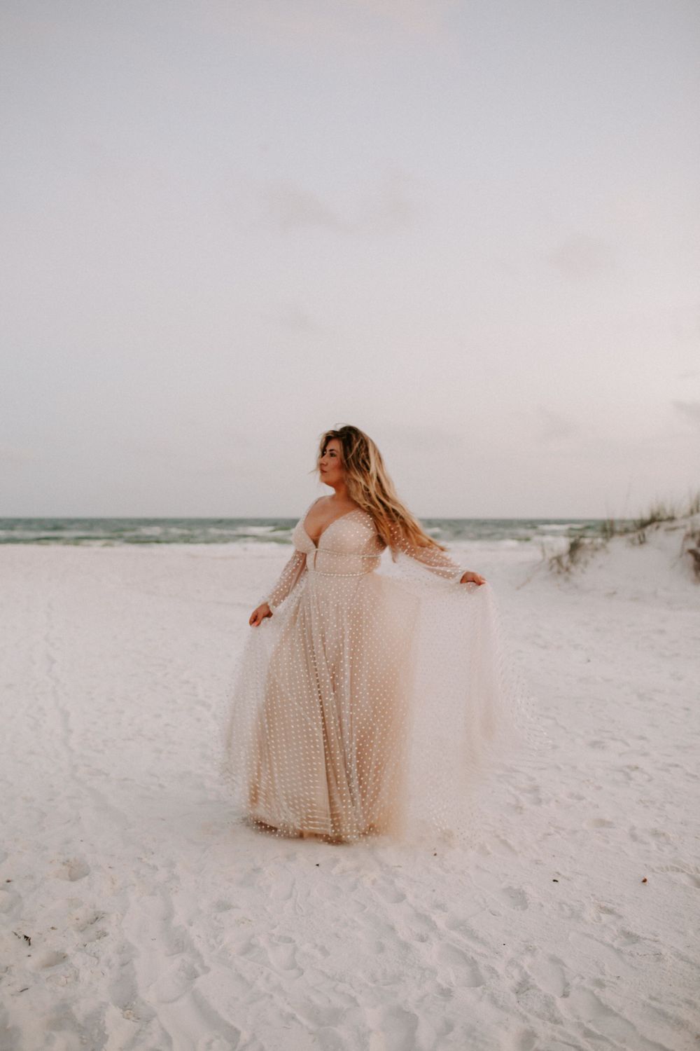 bride dancing on the beach