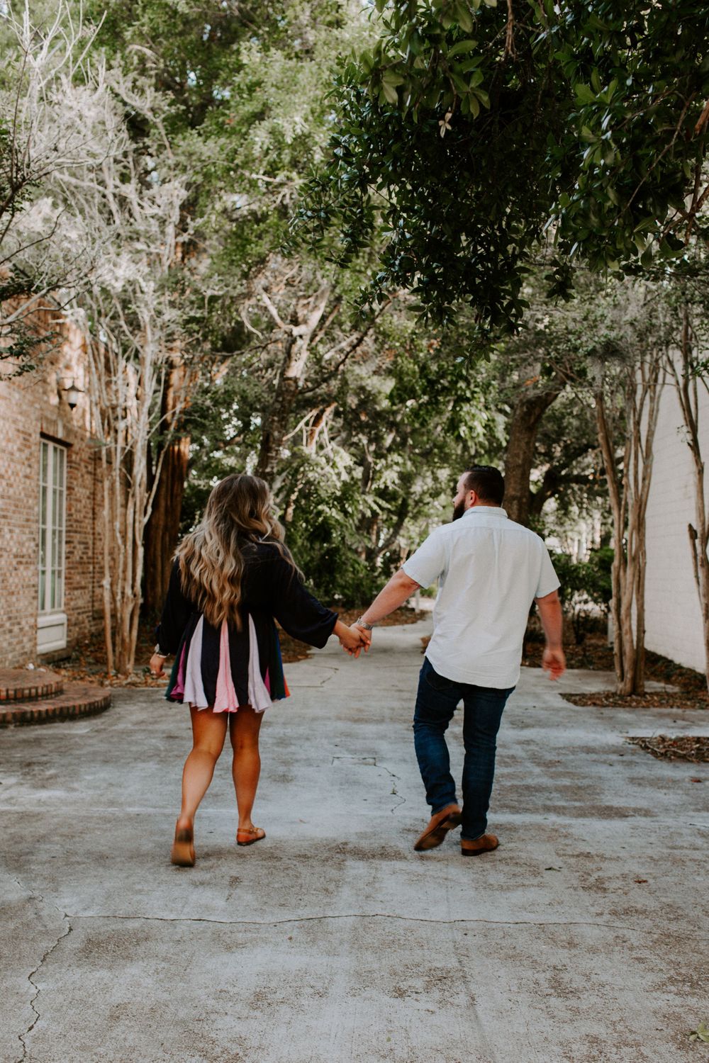 couple holding hands walking in Destin