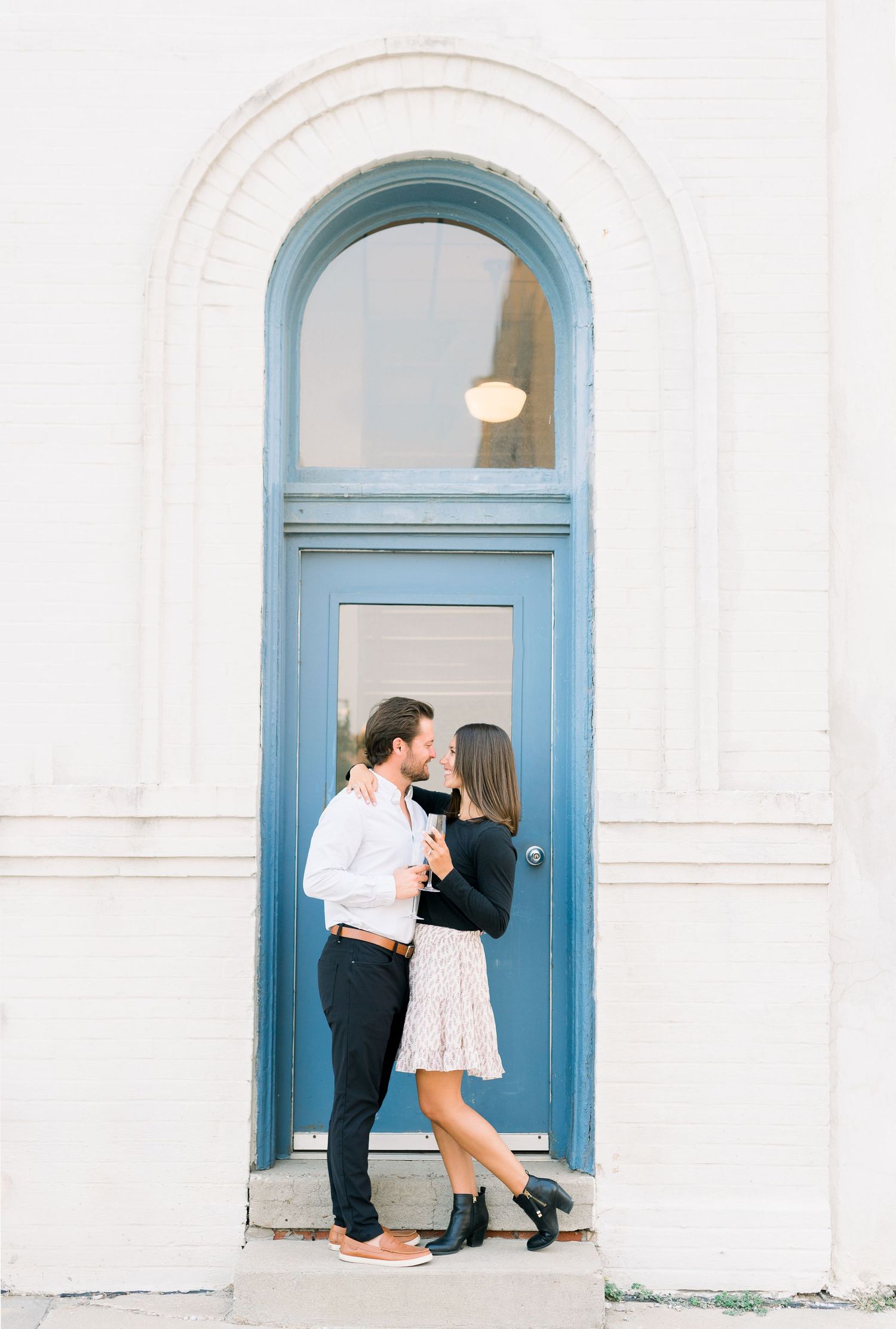 Des Moines Engagement photos in downtown Des Moines, Iowa with light and airy photographer Nicole Laing