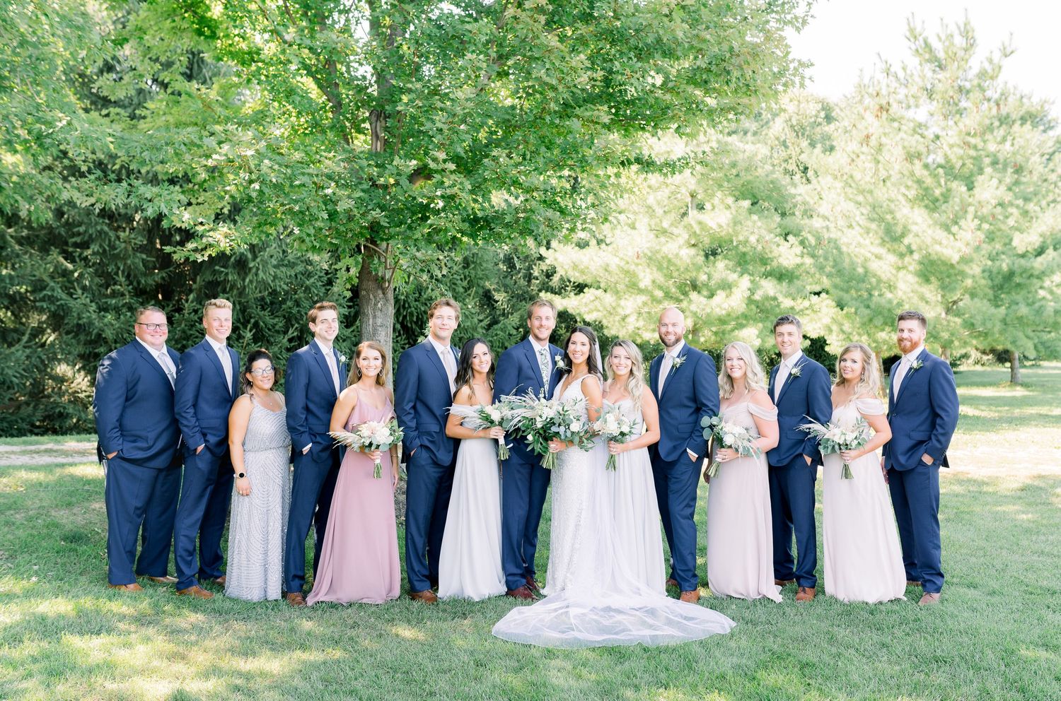 Vineyard bridal party photos with blue tuxes and pastel dresses at Prairie Moon Winery wedding in Ames, Iowa