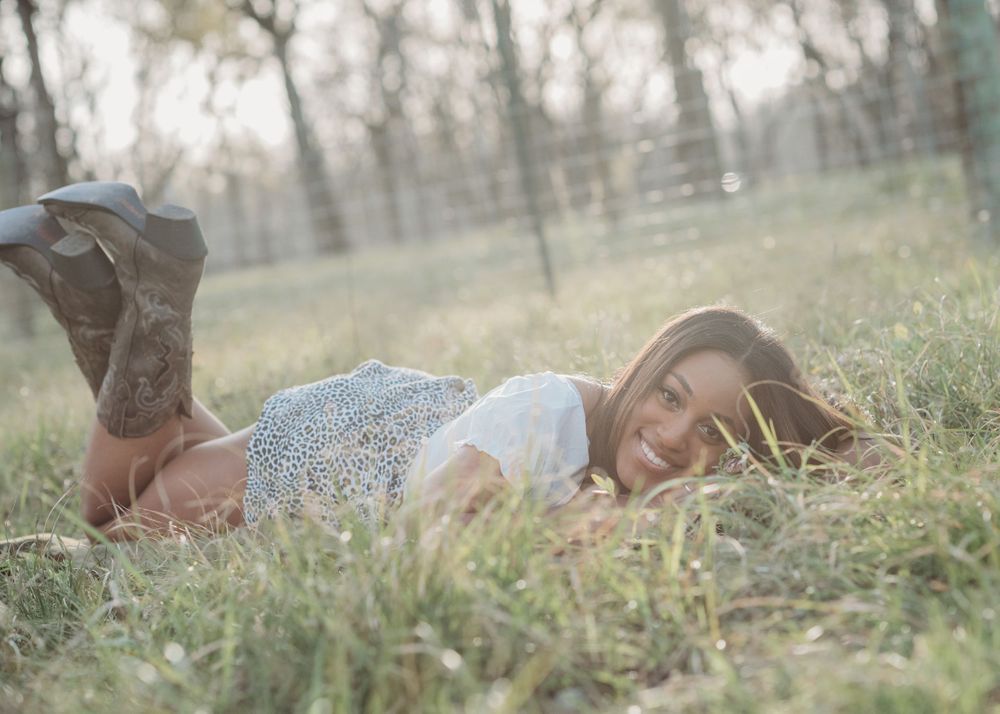 RidgePoint High School Senior Girl in Cowboy boots in field in Sienna Plantation