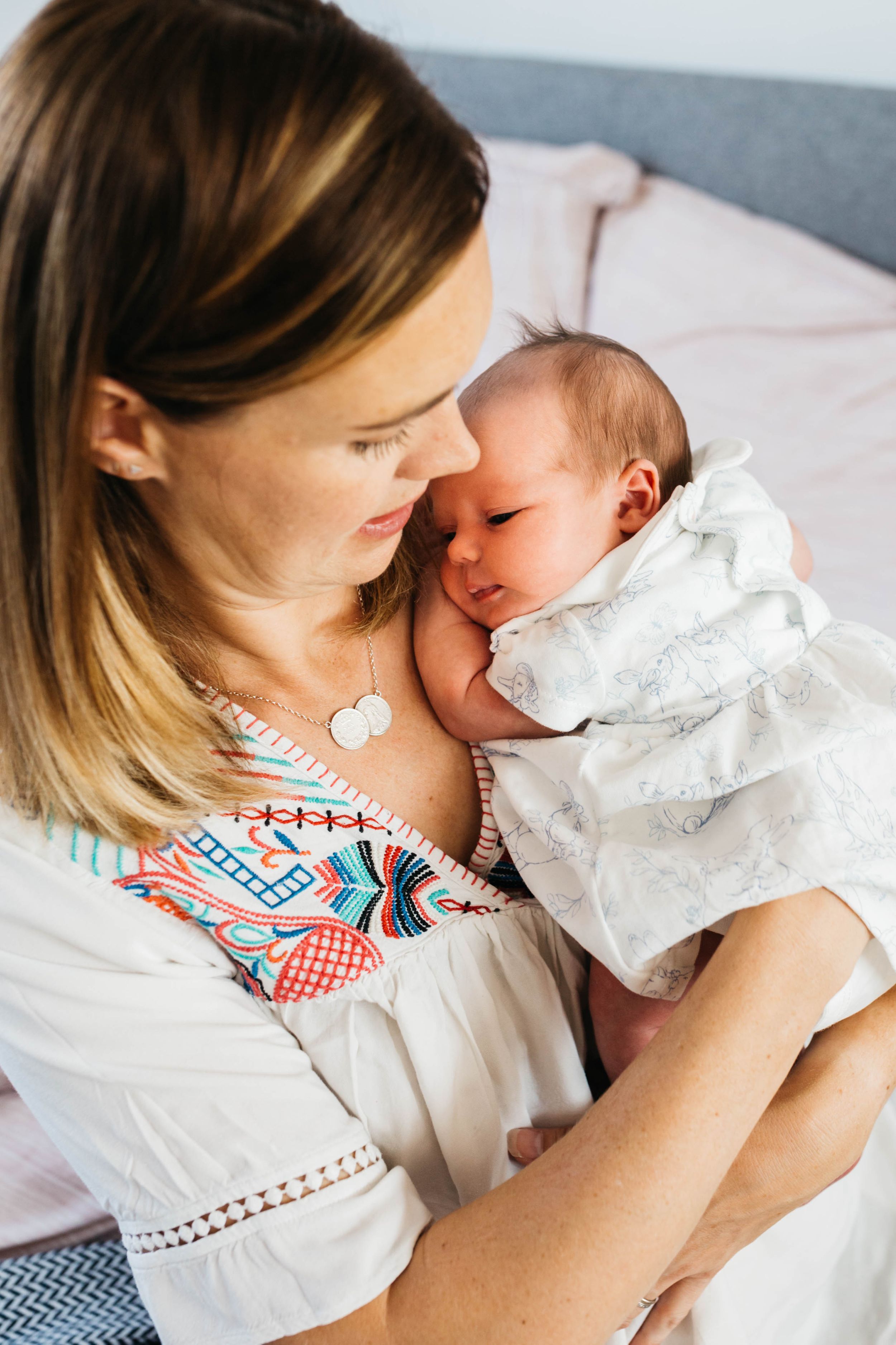 mum holding baby girl close to chest