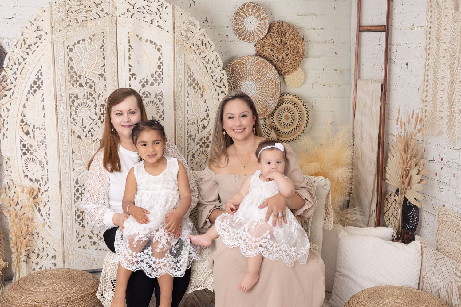 Family group seated together in front of decorative carved wall panel and woven basket wall decor.