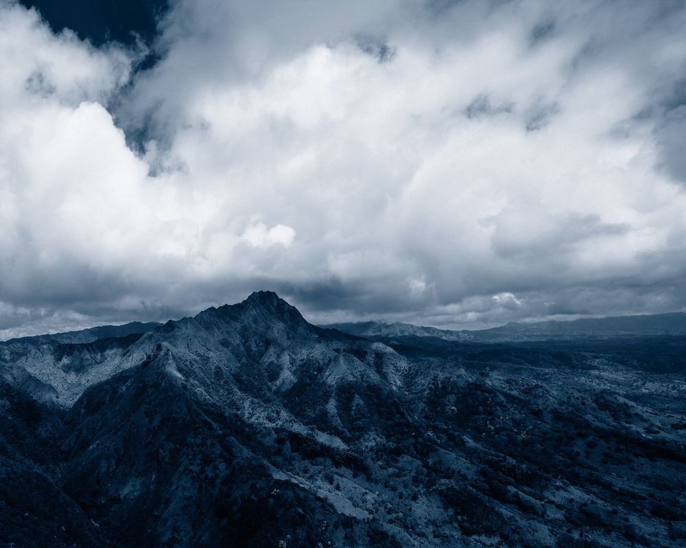 Prussian Blue monochromatic image of Hawaiian Mountain with clouds