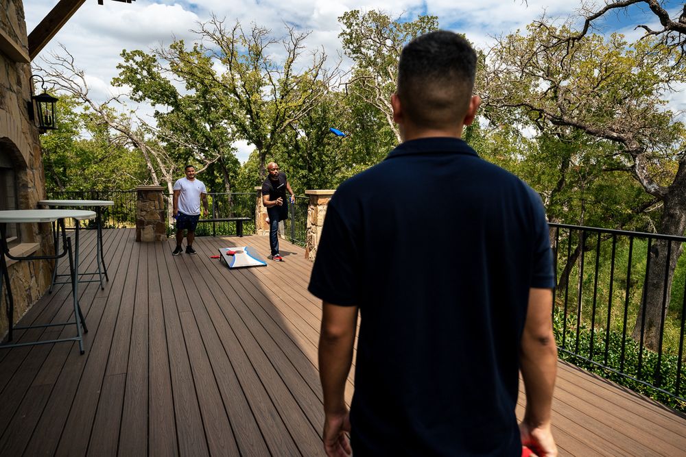 groom plays cornhole