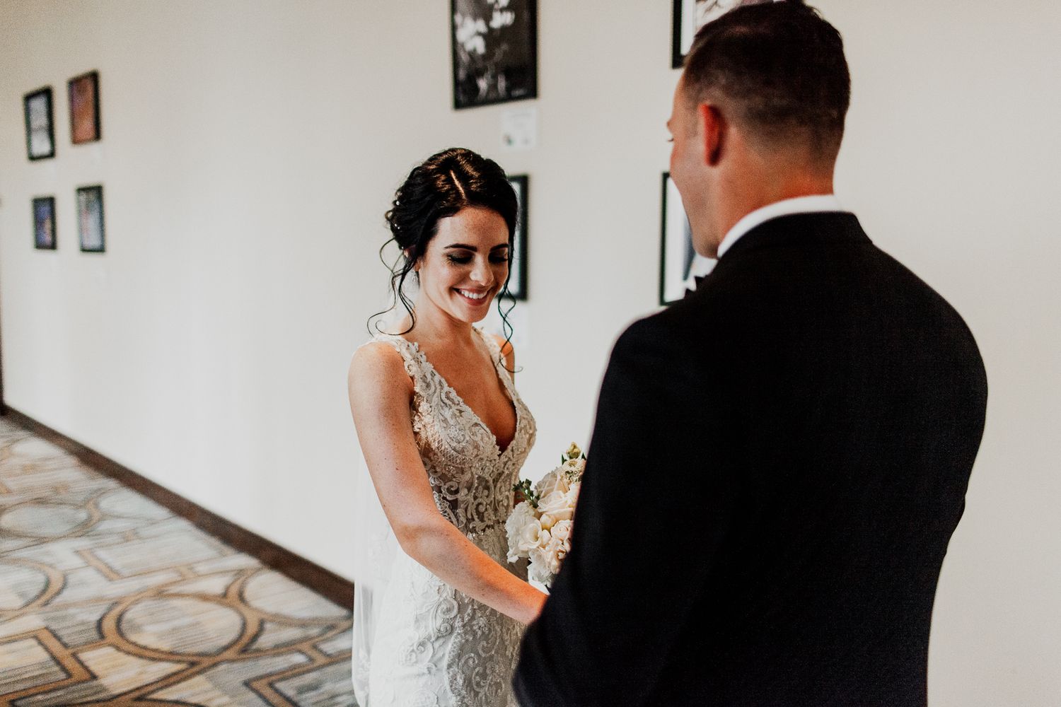 groom looking at bride in wedding dress