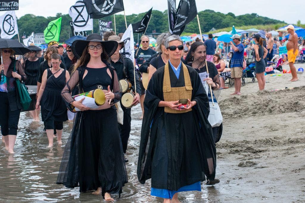 Zen Buddhist priest Myozen Joan Amaral of Zen Center North Shore Beverly leads funeral procession on Good Harbor Beach