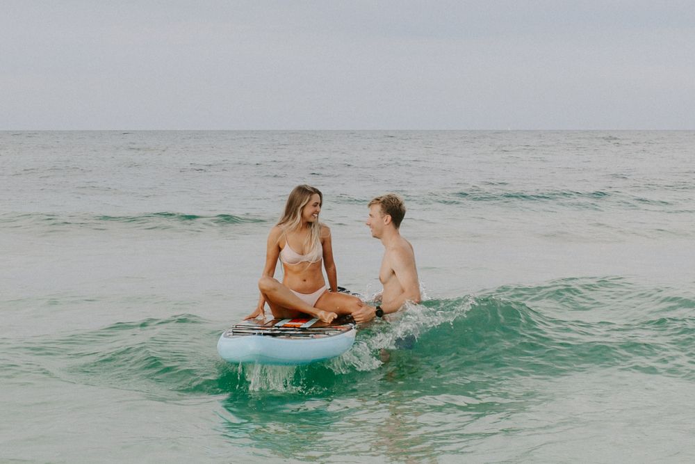couple surfing in the gulf