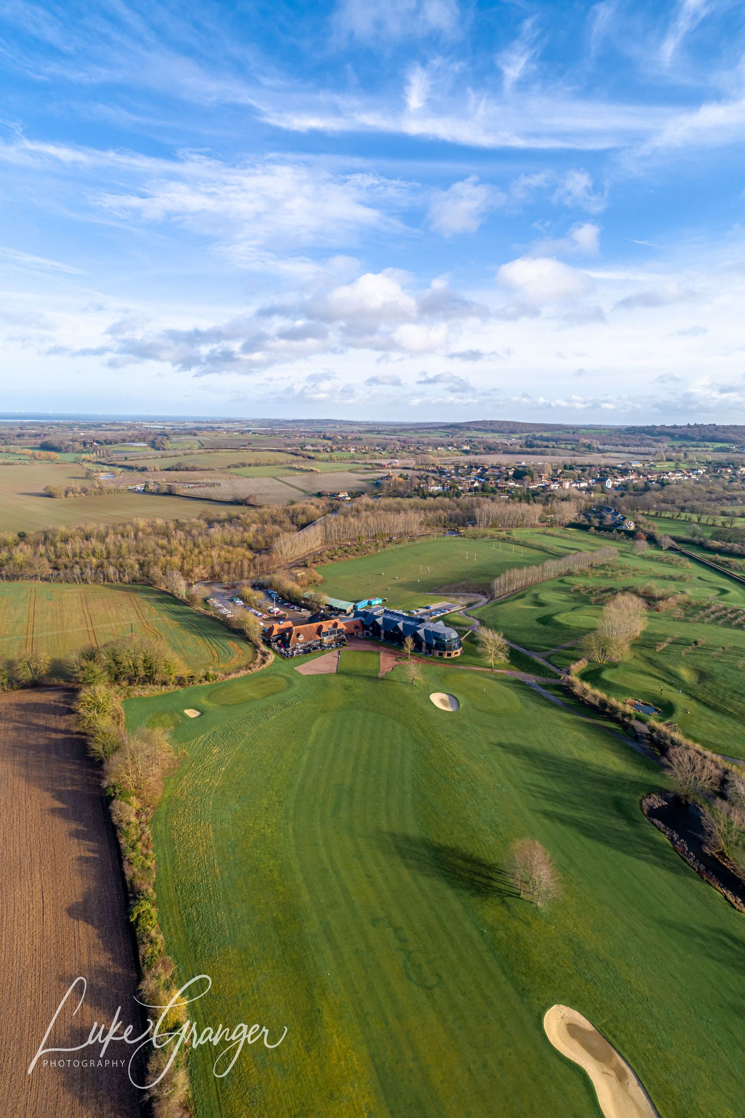 aerial drone photo of the cave hotel showing the golf course and venue with beautiful blue sky