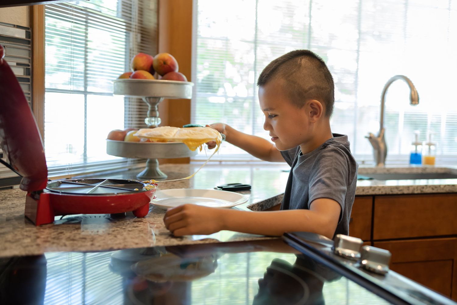 kid making quesadillas in kitchen Homeschooling entrepreneur mom Maple Valley, WA branding photo
