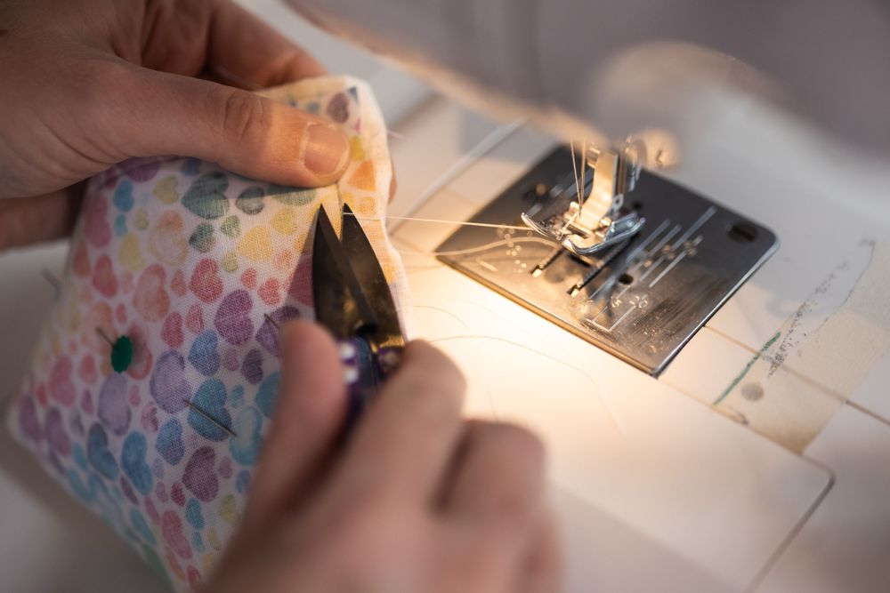 The process of sewing, branding photos taken by Jane Nicholson Photography.