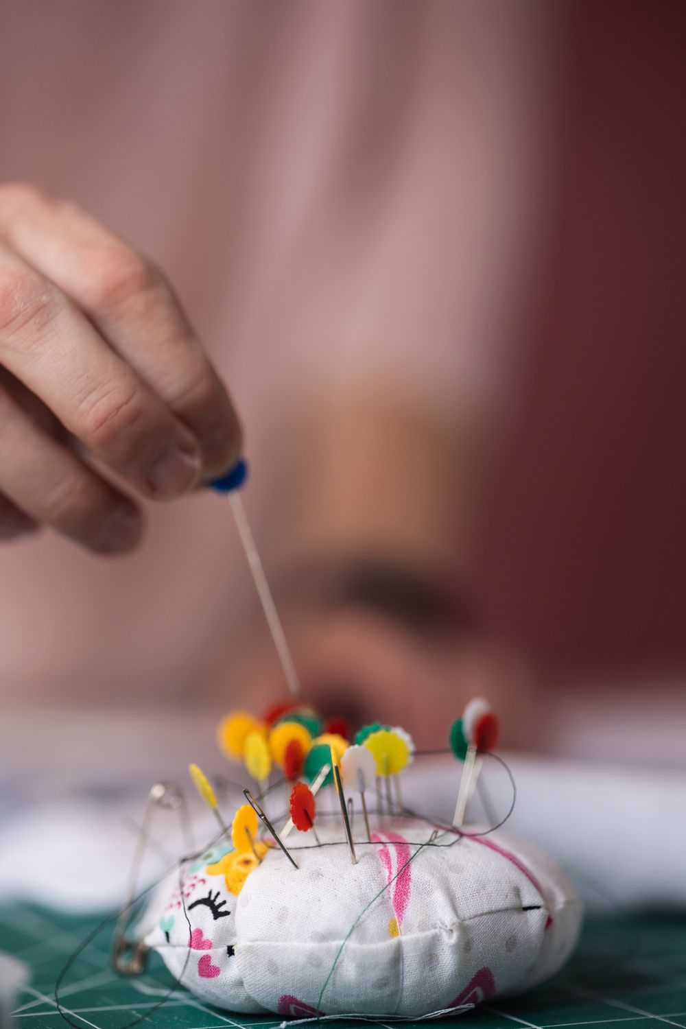 Close up detail image of small business owner, Ruth using the tools for her business of sewing. Taken in her studio in New Barnet.