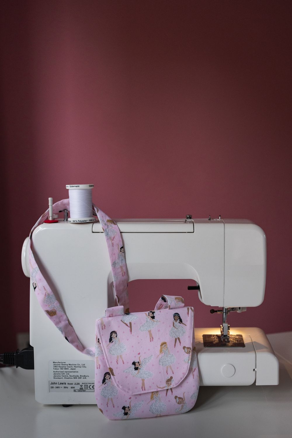 Lifestyle product photography of handmade bag, propped up against sewing machine.