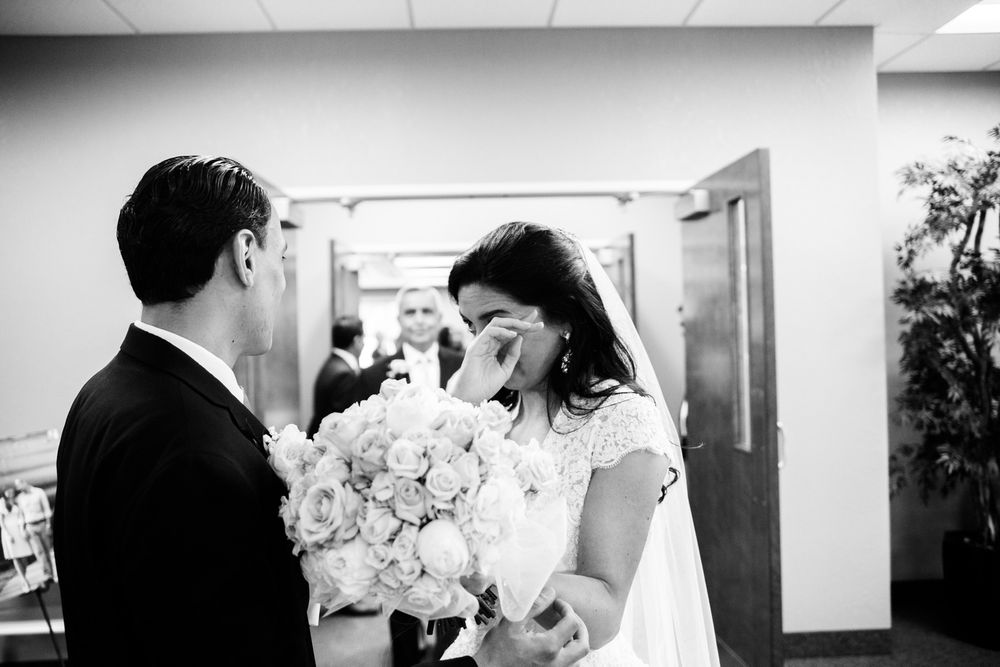 Bride wipes away tears after wedding ceremony