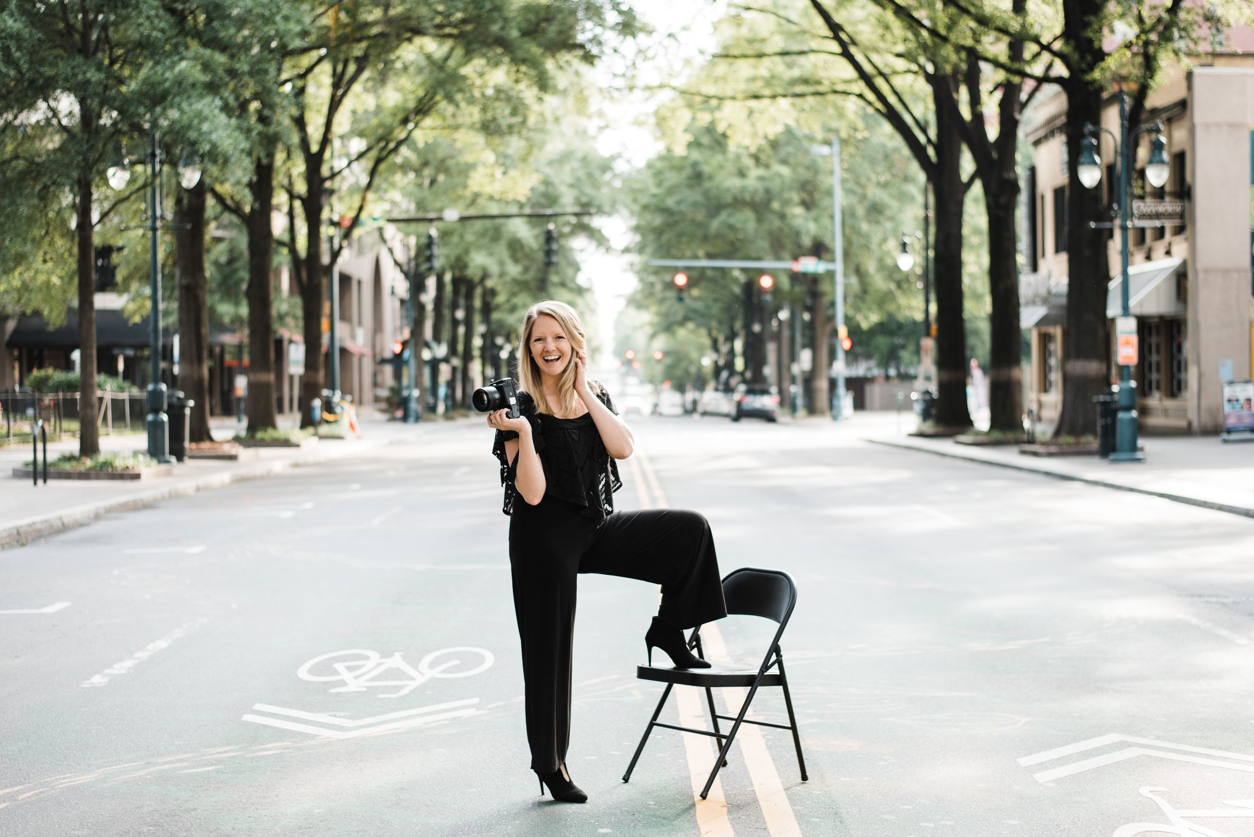 Rachel McIntyre with Kharis Photography standing in Charlotte NC Uptown street
