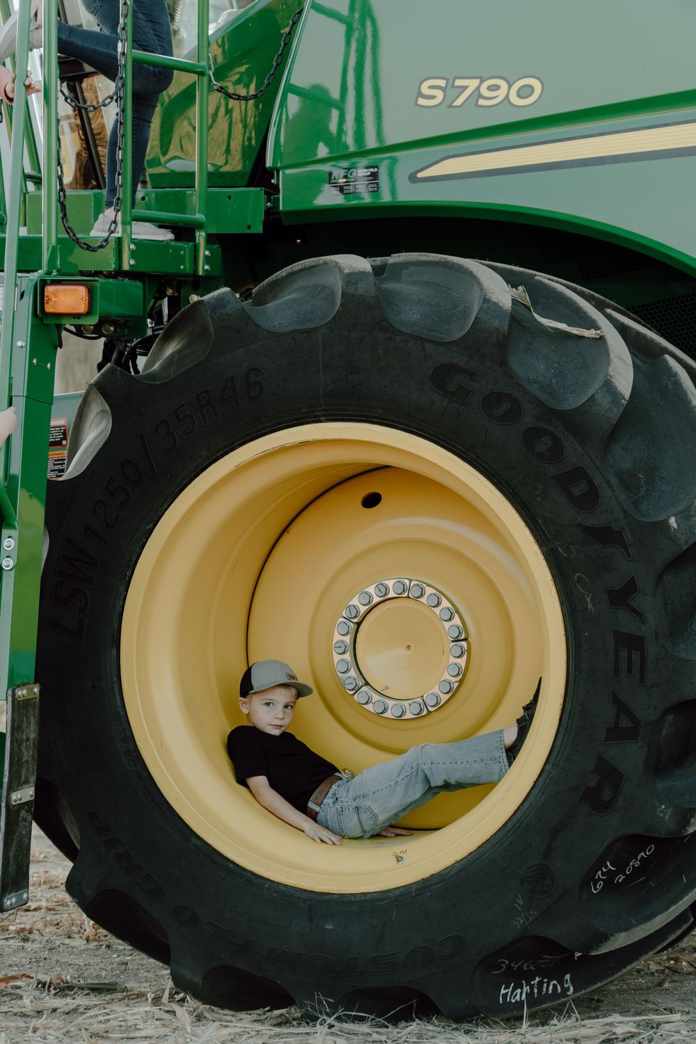 Massive agricultural tire and wheel of a John Deere S790 combine harvester.