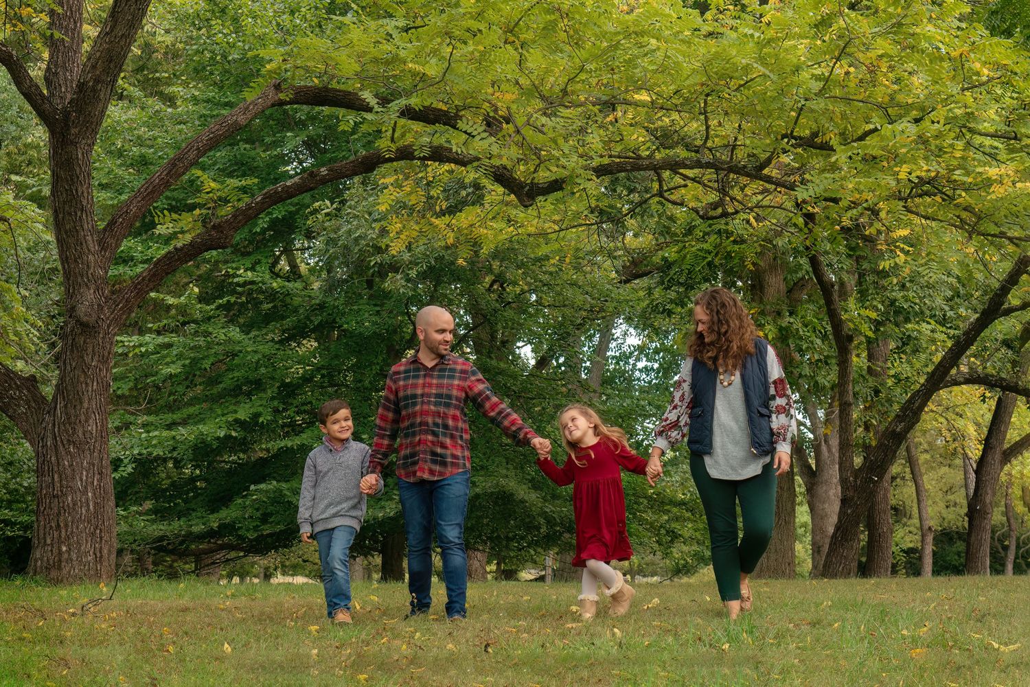 family walks together through treed field