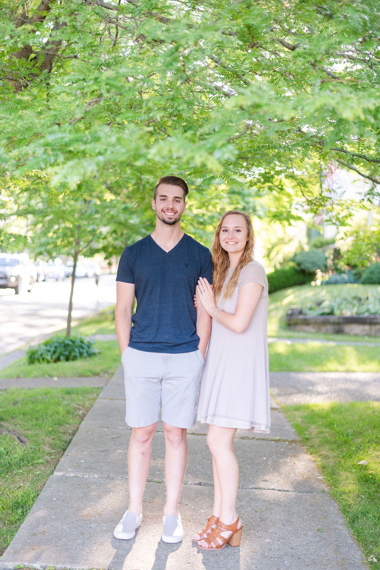 Couple standing on sidewalk for engagement in Franklin Pennsylvania